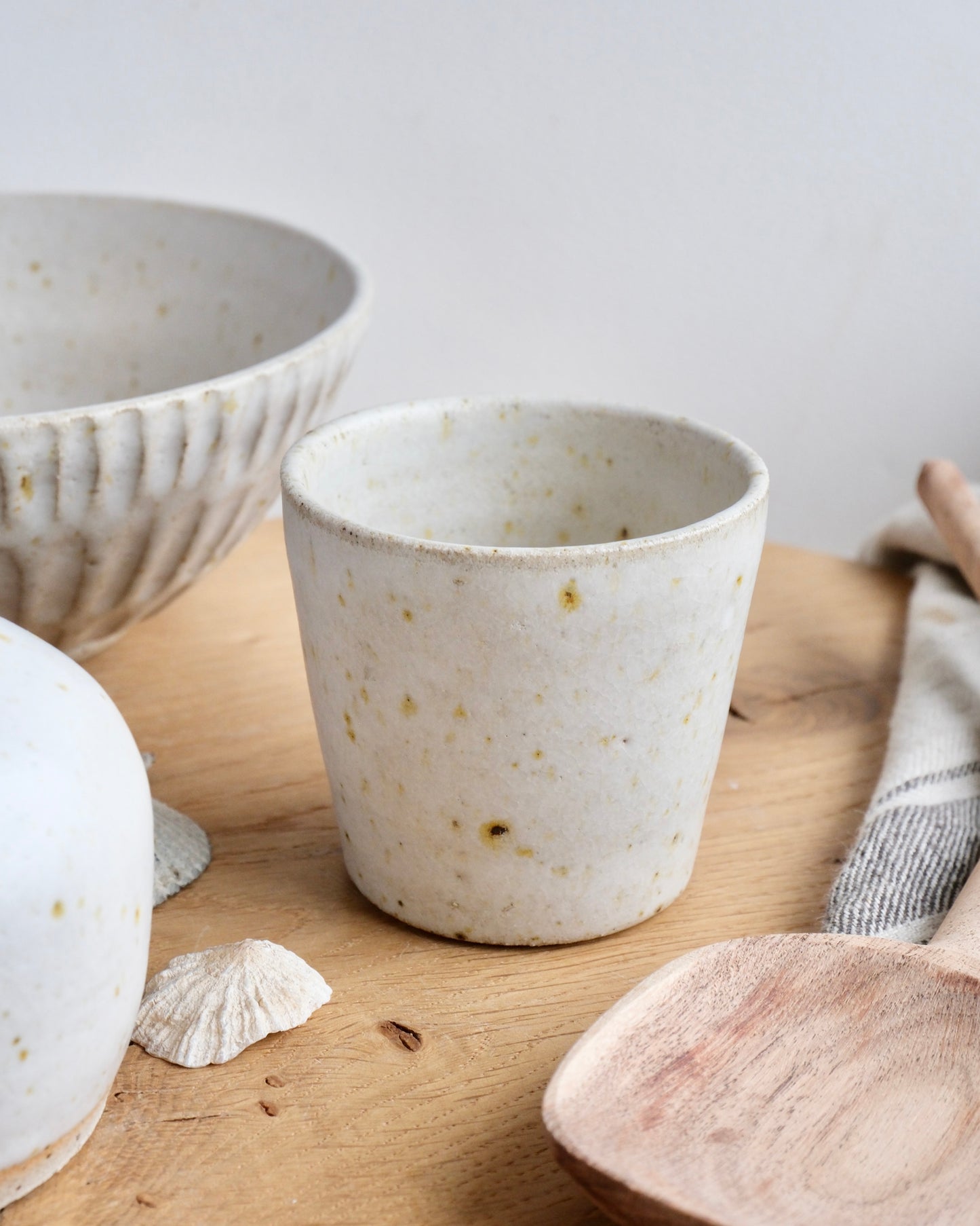 A collection of white speckled ceramic items