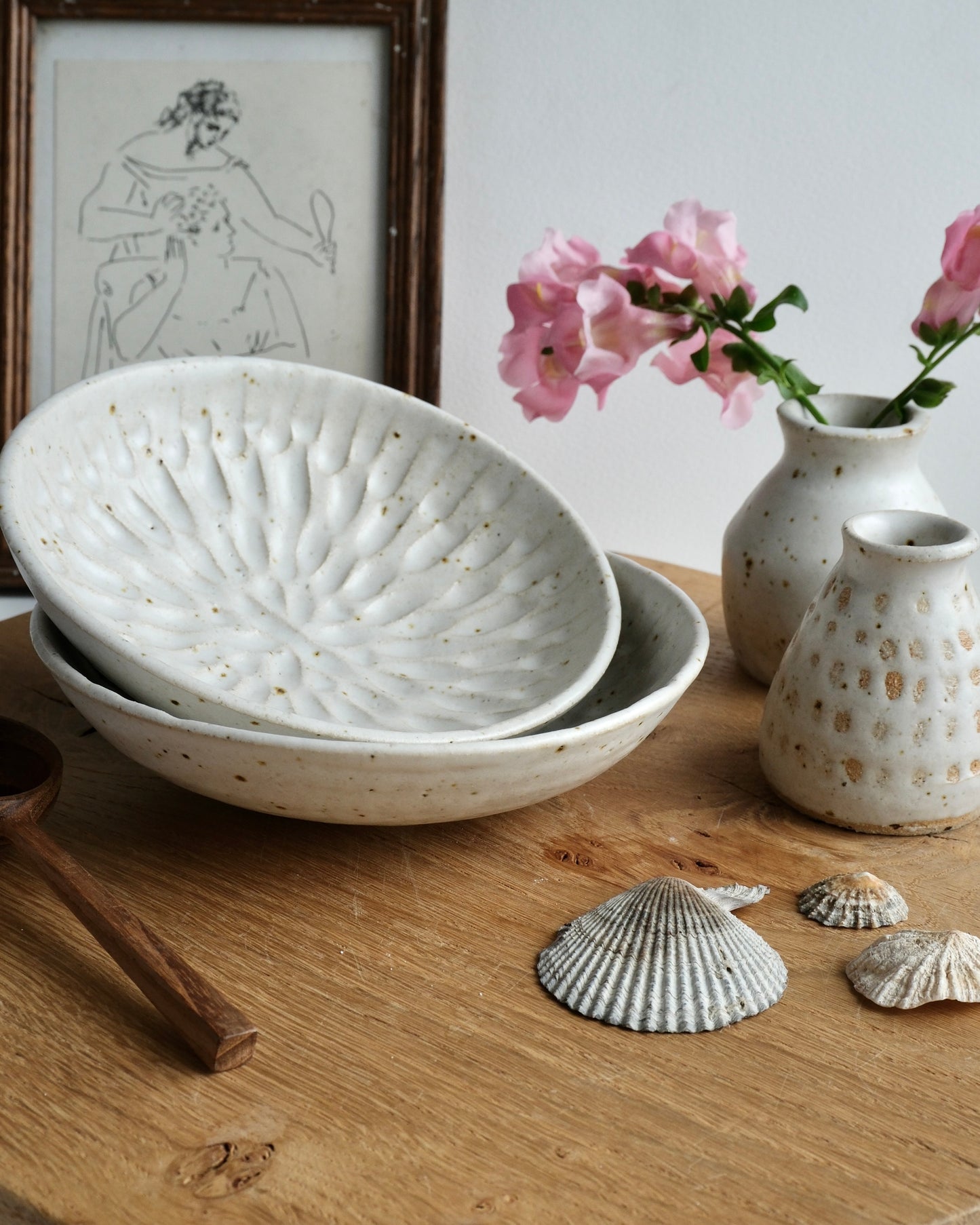 A collection of white ceramic items on a wooden board