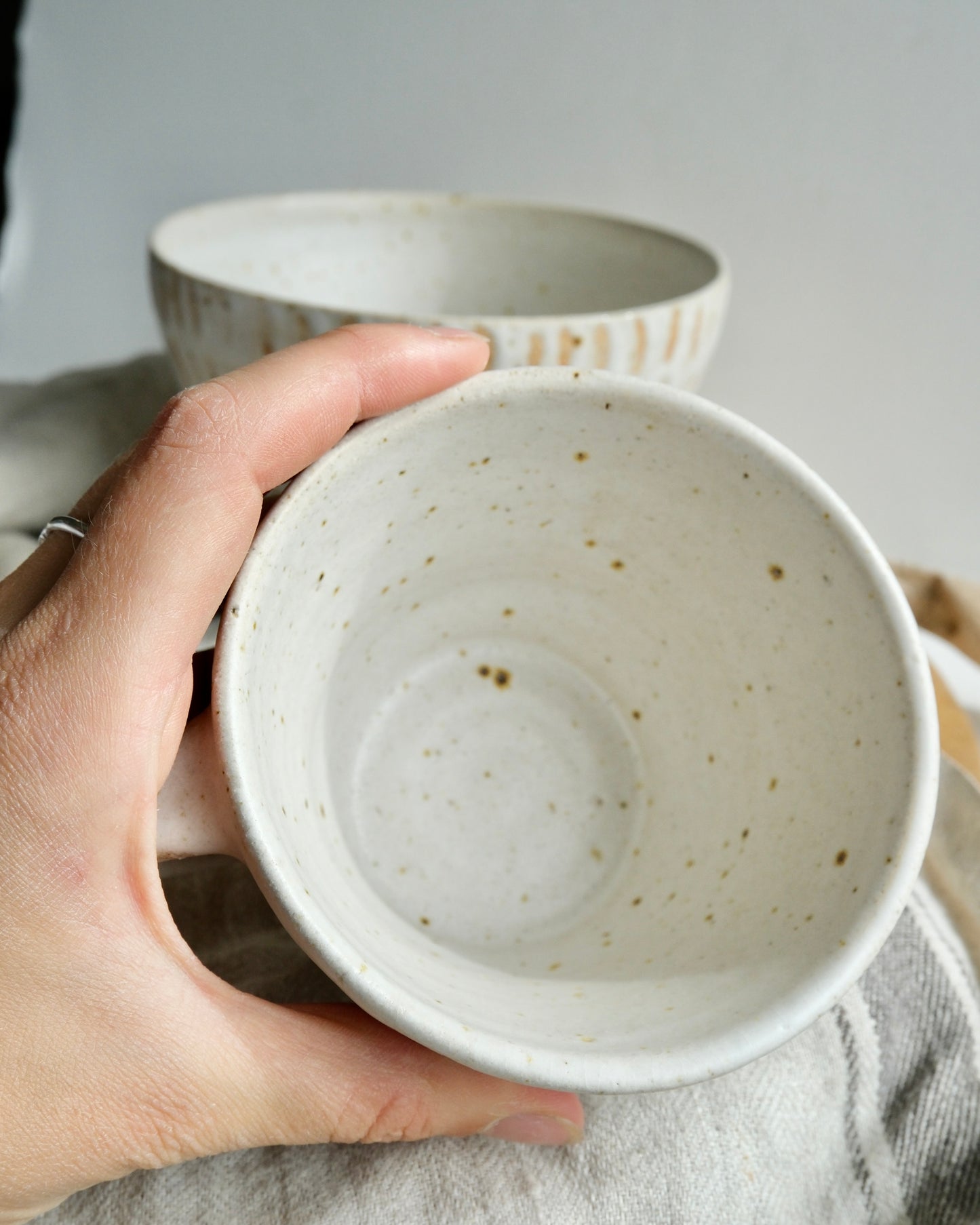 The inside of a white speckled tea mug 