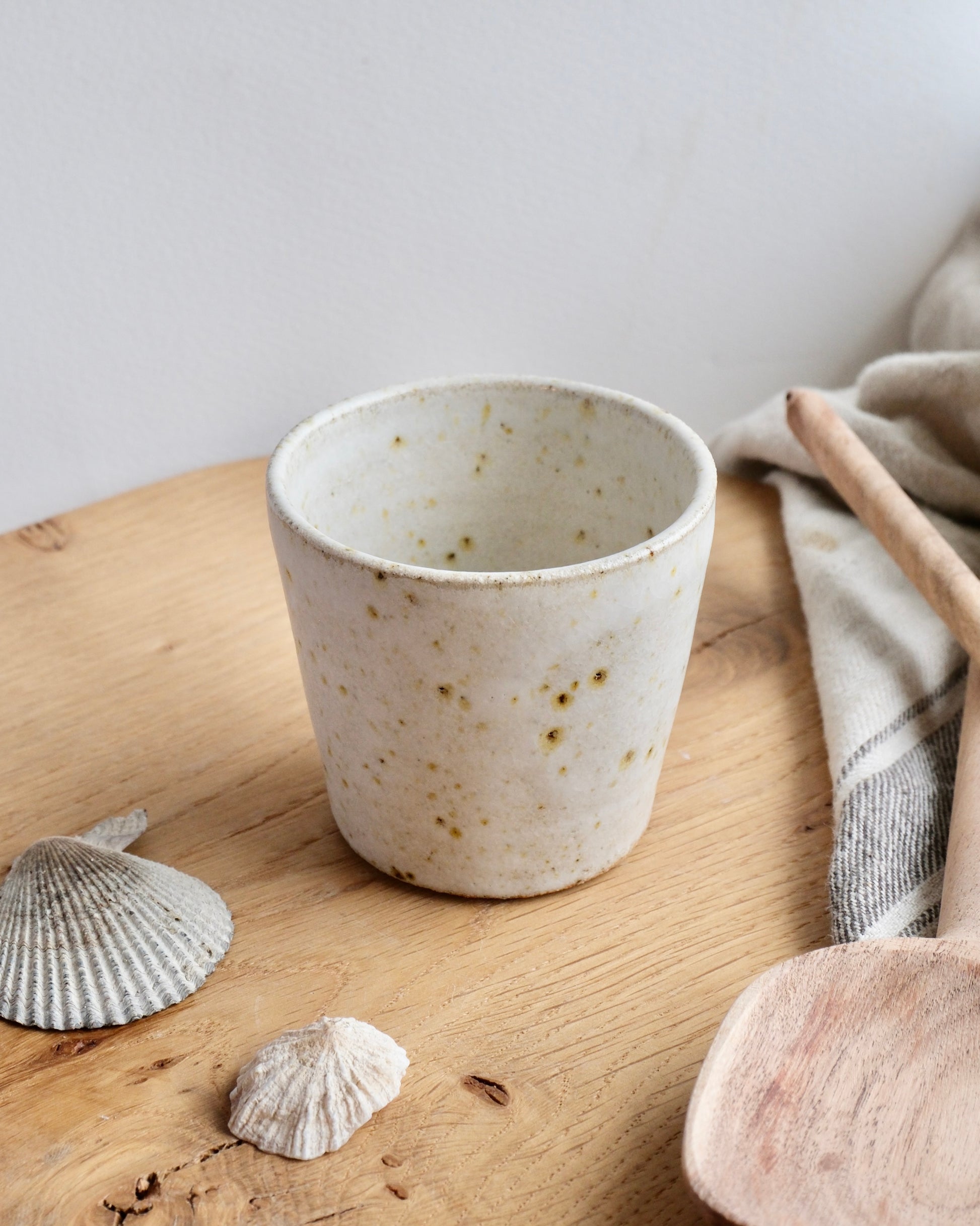 looking down at a white speckled stoneware espresso cup 