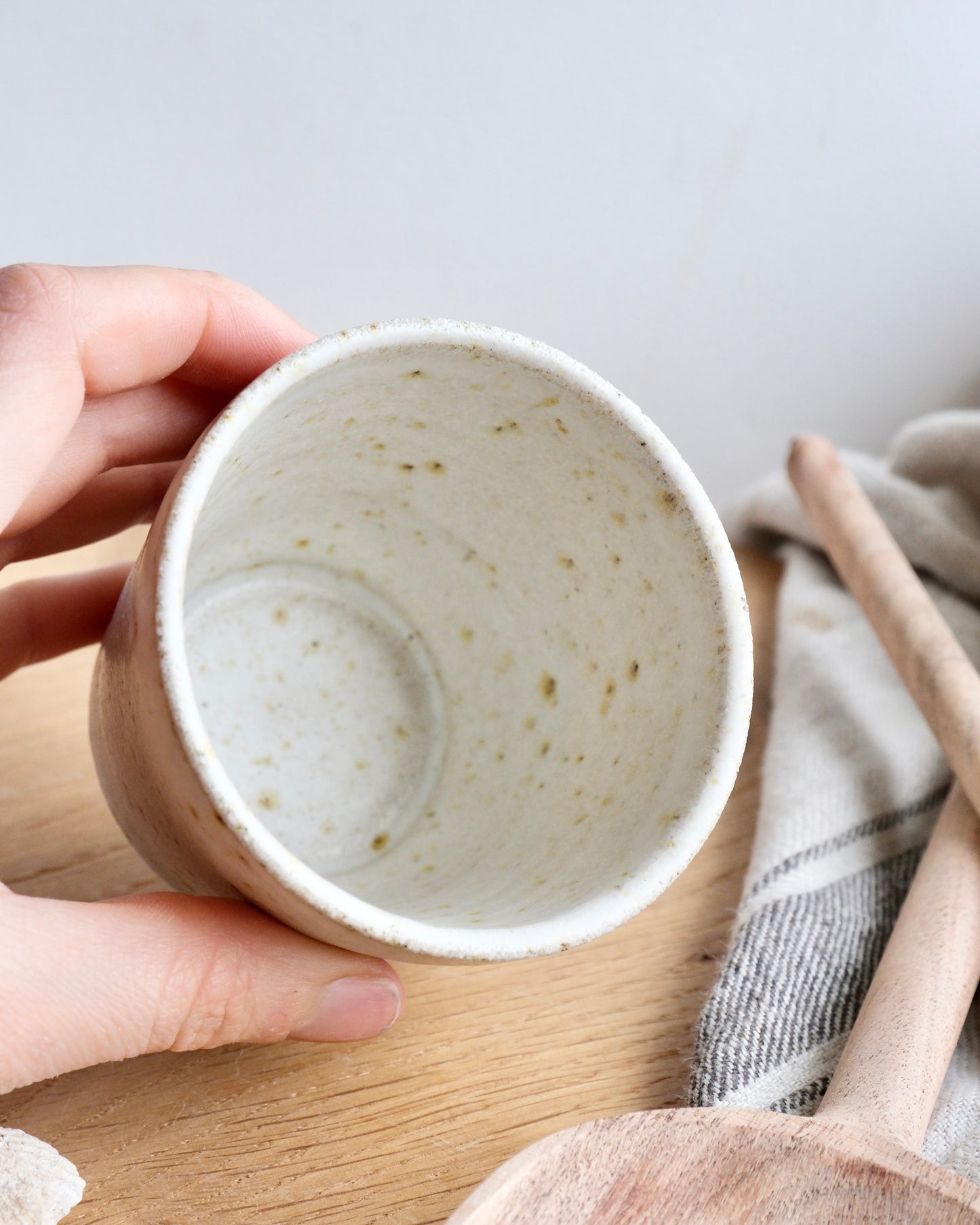 A close up of the inside of a white speckled cup 