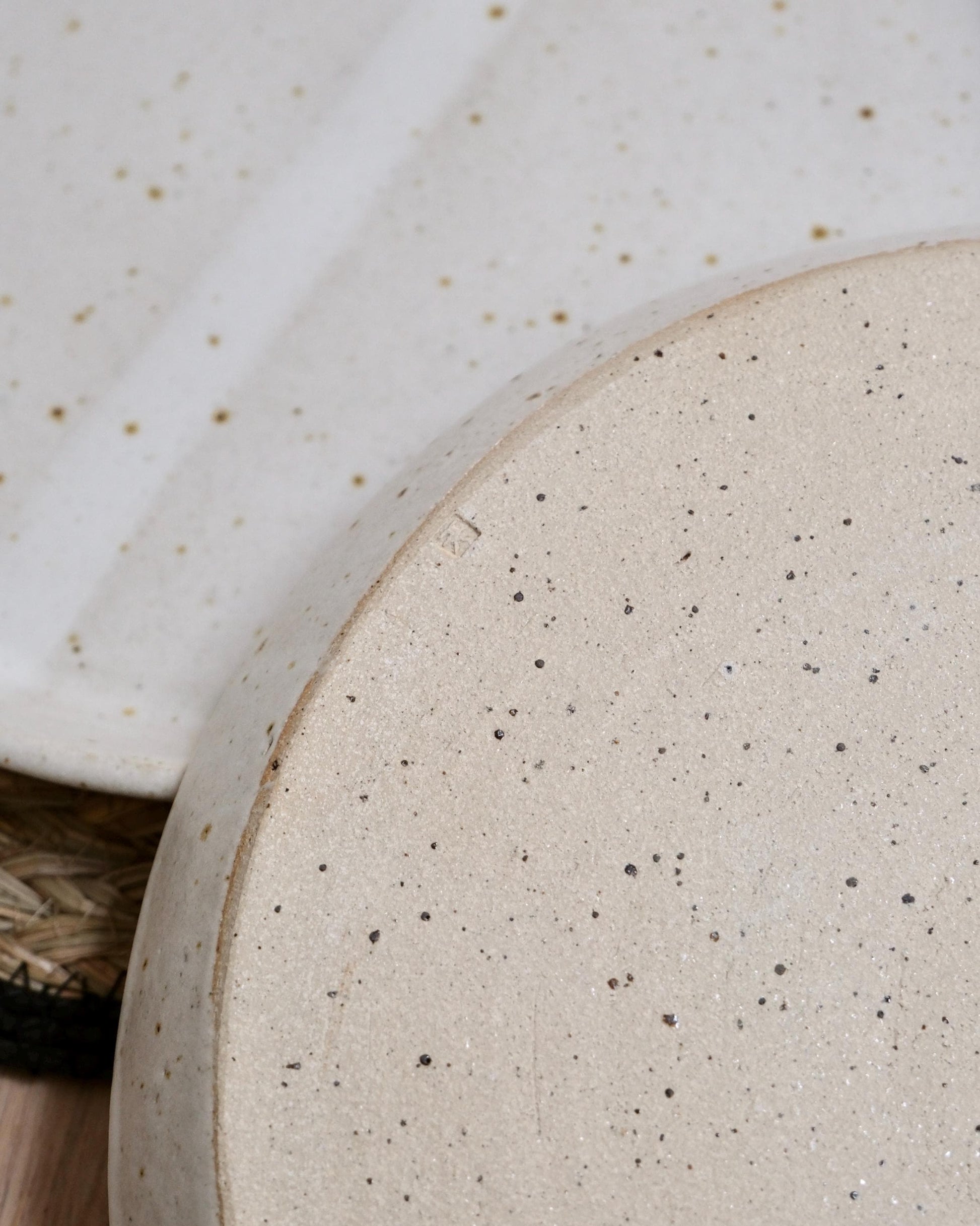 Close-up of a ceramic plate with speckled texture